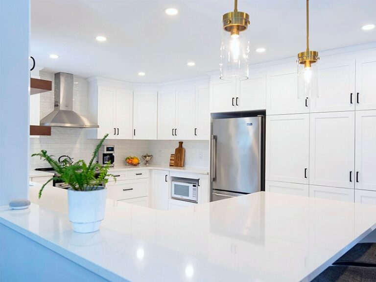 Elegant monochromatic kitchen renovation with gold finishes