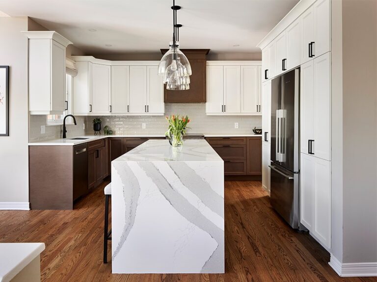Ottawa kitchen renovation with two-tone cabinets and stunning quartz waterfall countertop